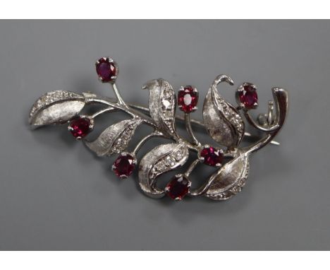 A modern 18ct white gold, ruby, diamond set leaf brooch, 41mm.