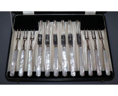 A cased matched set of six pairs of George V mother of pearl handled silver dessert eaters.