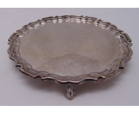 A Mappin and Webb hallmarked silver card tray with double scroll border on three scroll feet, Sheffield 1972, approx total we