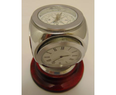 A quartz clock of cubic form with compass, hydrometer and thermometer on raised circular base, 11cm (h)