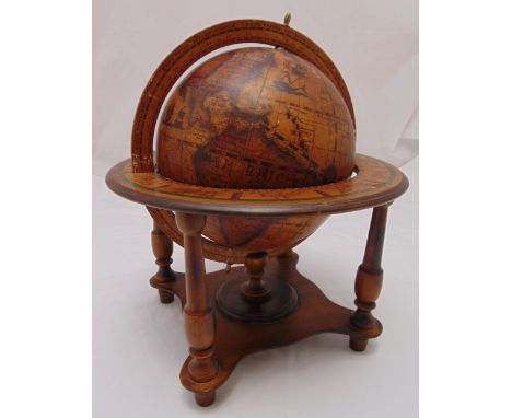 An Olde World Globe mounted in a mahogany stand with four supporting columns on peg feet, 38cm (h)