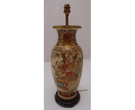 An oriental baluster form lamp base decorated with panels of warriors in full armour on carved hardwood base, 49.5cm (h)