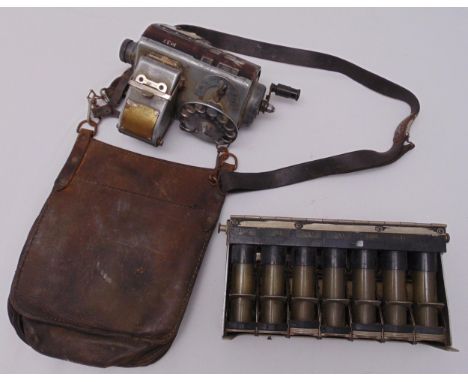 An early 20th century bus conductors ticket machine with leather pouch and an early metal change machine
