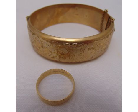 9ct gold wedding band and a 9ct gold bangle, approx total weight 33.7g