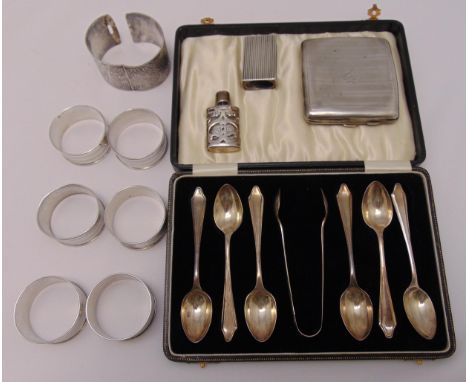 A quantity of hallmarked silver and white metal to include napkin rings, a cigarette case, a matchbox holder, a bangle and mi