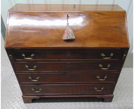 A 19th century rectangular mahogany bureau , the four drawers with brass swing handles on four bracket feet, the drop flap re