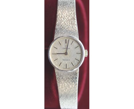 Omega Geneve 9ct gold ladies wristwatch on a 9ct gold bracelet, having paperwork and both inner and outer boxes, 33.1g total.