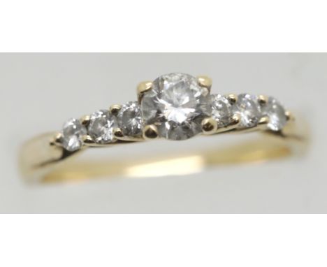 Presumed 18ct gold diamond solitaire ring with central brilliant cut stone approx 0.25 cts and diamond shoulders, size M, 2.9