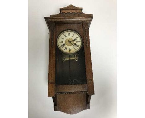 An Edwardian oak wall clock 