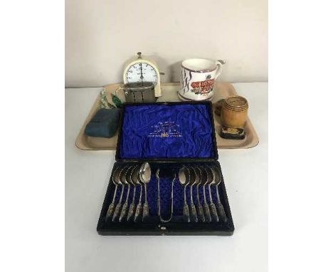 A tray of set of twelve cased plated table spoons and tongs, Lloyds Bank money box, mid 20th century Smiths stop clock, Sunde