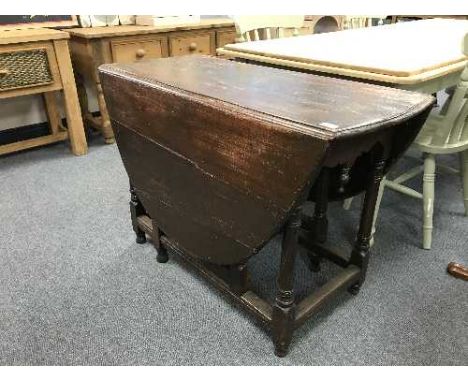 An antique oak gate leg table 