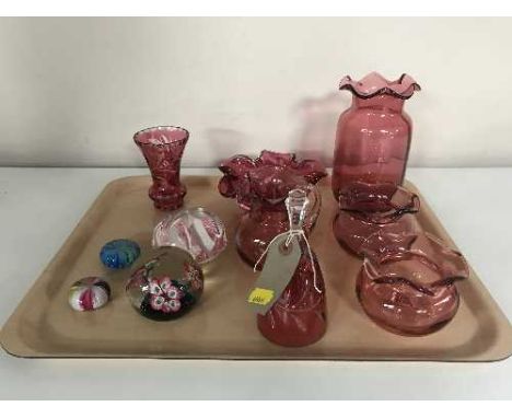 A tray of seven pieces of cranberry glass and four glass paperweights 