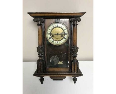An Edwardian wall clock with enamelled dial 