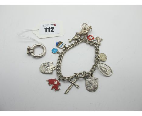 A Curb Link Souvenir Charm Bracelet, suspending enamel shield charms, cross, carriage, giraffe etc; a large clasp, stamped "9