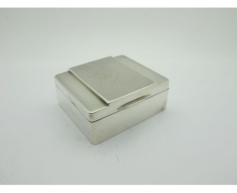 A Hallmarked Silver Cigarette Box, Birmingham 1952 (marks rubbed), with engine turned hinged lid (dented), 8.7cm wide. 