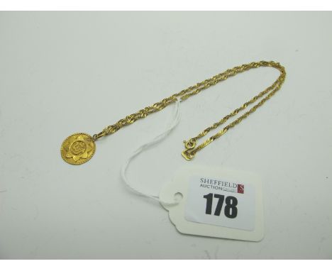 A Fancy Link Chain, stamped "750", suspending a disc pendant.