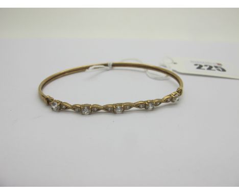 A Modern 9ct Gold Bangle, with claw and inset highlights (4.2grams). 