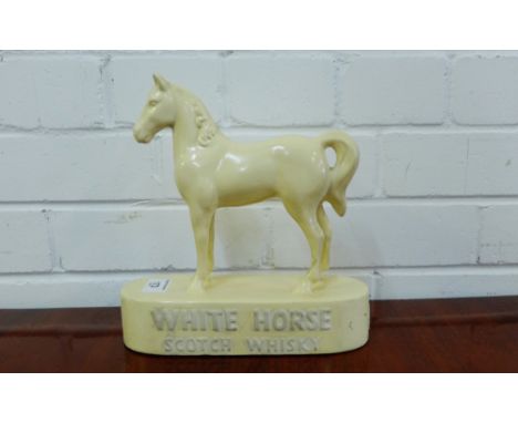 A Whitehorse Scotch Whisky advertising figure, 23cm high