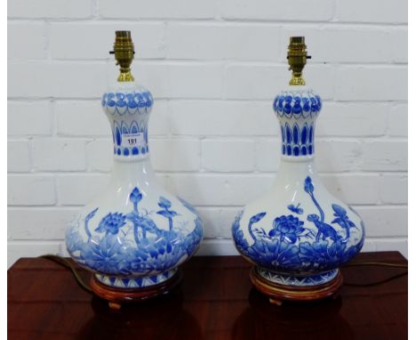 A pair of contemporary Chinese style blue and white baluster table lamp bases on turned wood stand, 40cm high, excluding ligh