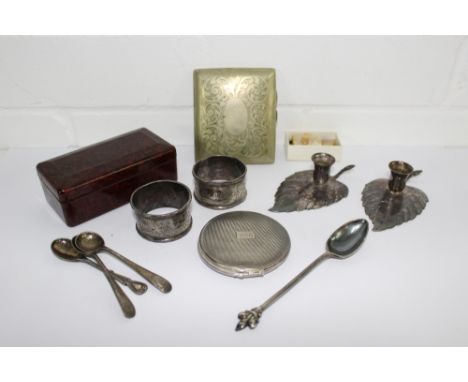 A mixed lot to include a silver powder compact, two silver napkin rings, Epns taper stick holders, miscellaneous salt spoons,