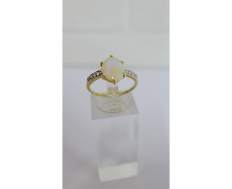 A 9 carat gold Australian Coober Pedy opal set dress ring, with small diamond chips to the shoulders UK ring size Q 