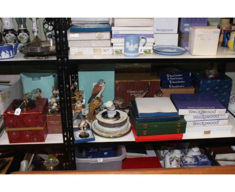 Shelf of Border Fine Art ornaments, Royal Doulton and Wedgwood plates.