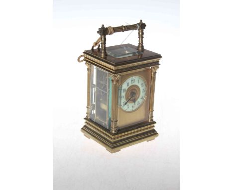 Gilt brass striking carriage clock, the case having corinthian columns and bevelled glass panels, 20cm to handle.