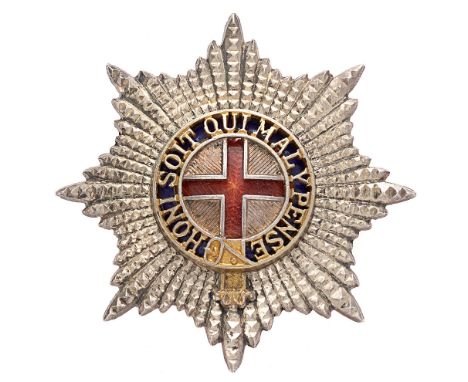 Coldstream Guards Warrant Officer cap badge.  Fine die-stamped facetted silvered star; the gilt wash Garter pierced with blue