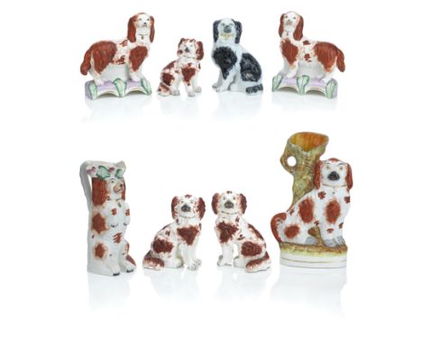 A collection of Staffordshire models of spaniels19th centuryComprising a pair of spaniels standing on pink bases applied with