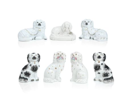 A collection of Staffordshire models of spaniels19th and 20th centuryComprising a pair of seated spaniels with colourful bask