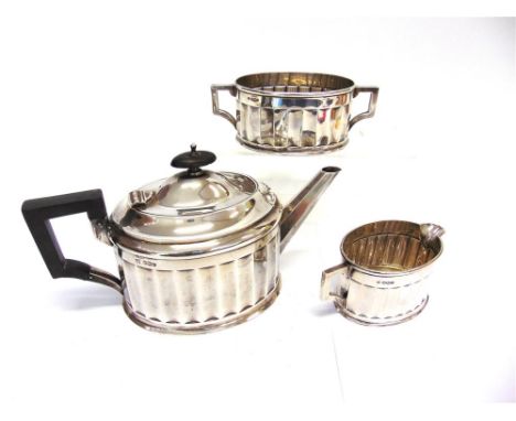 AN ART DECO THREE PIECE SILVER TEA SERVICE  by Boardman, Glassop & Co, Sheffield 1924, of oval panelled form, inscribed to th