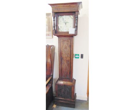 A 30-HOUR LONGCASE CLOCK  in carved oak case, the enamel dial with painted decoration and calendar aperture, the name indisti