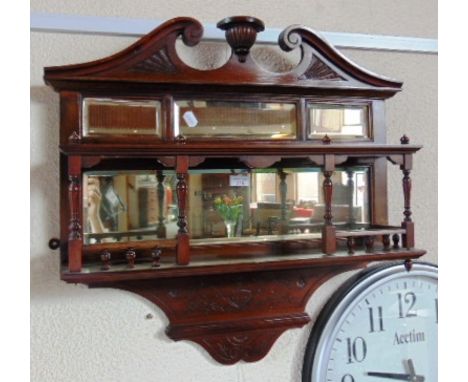 A CARVED WALNUT MIRRORED HANGING SHELF BRACKET  74cm wide 72cm high