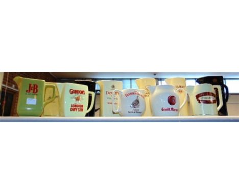 BREWERIANA - ELEVEN CERAMIC WATER JUGS by Wade, including Gordon's London Dry Gin, Dewar's White Label and Grand Marnier.