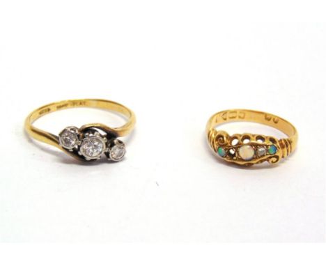 A THREE STONE DIAMOND RING stamped '18ct Plat', the graduated illusion set brilliant cuts totalling approximately 0.36 carats