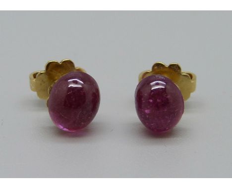 A pair of 18ct gold cabochon ruby earrings with screw backs, one stone a/f 