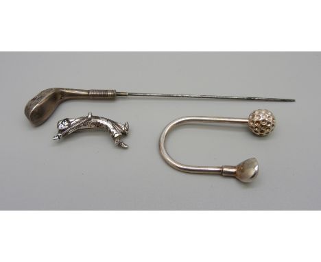 A silver hat pin in the form of a golf club, a/f, a silver golf key ring and a golfer brooch 