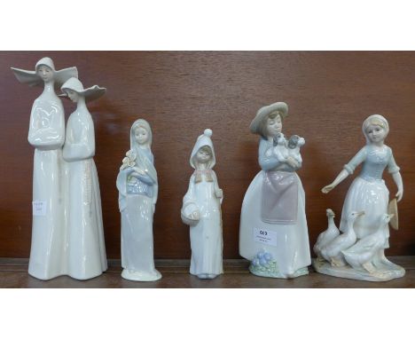 A Lladro figure of two nuns, a Lladro figure of a girl holding a bunch of flowers, a Nao figure of a girl with two dogs, one 