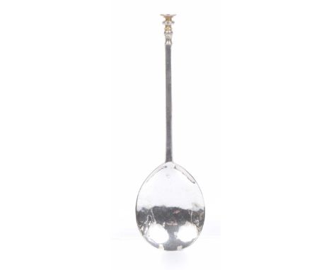 An early 17th century English Provincial silver seal top spoon The tapered faceted stem with fluted baluster knop, the disk b