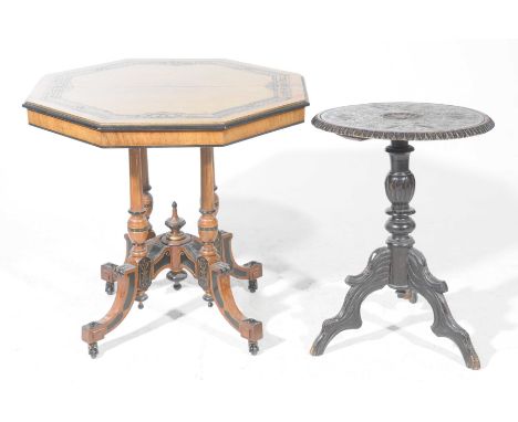 A Victorian walnut octagonal centre table and a carved tripod tableThe octagonal centre table with an ebonised border, raised