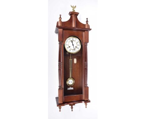 A 20th Century Vienna style wall clockThe carved architectural casing adorned with scalloped pediment and eagle and ball fini