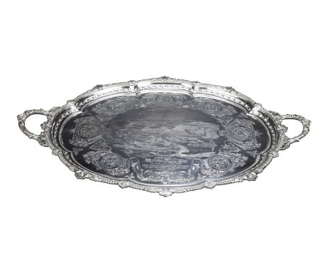 An impressive Victorian twin handled silver presentation trayOf shaped oval form, with beaded and fluted graduated borders, c
