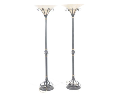 A pair of contemporary painted iron and opaque glass up lighter lamp standards Each with a trumpet shaped opaque glass shade 