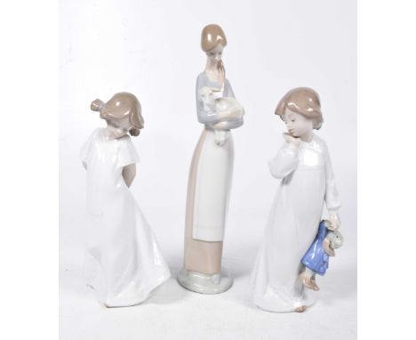 A collection of Lladro and Nao figuresTo include a Lladro figure of a young girl holding a lamb and two further Nao figures. 