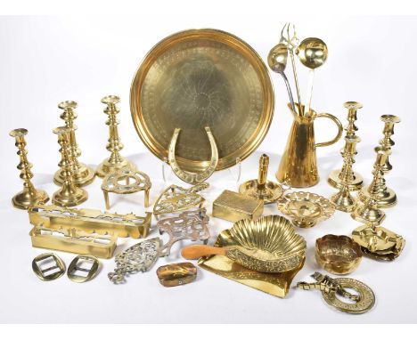 A quantity of various brass wareTo include a group of 19th Century knopped candlesticks, a group of trivets, chamber stick, v