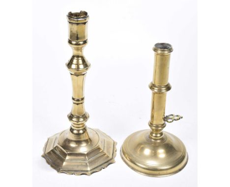 Two English 18th/19th century candlesticksThe first with a faceted knopped stem rising from a domed and scalloped foot, 24cm 