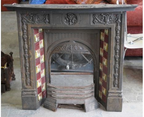 An early 20th Century cast iron fire surroundWith a bowfront painted hardwood mantle piece above the fire surround cast with 