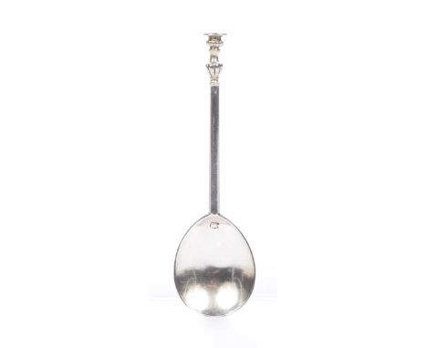 A Charles I English silver seal top spoon The tapered faceted stem with fluted baluster knop, the flat disk engraved with a c