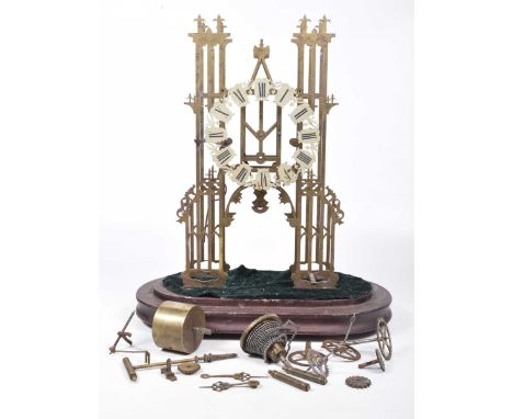 A late 19th Century/early 20th Century brass skeleton clock (in need of restoration)The architectural case with enamel chapte