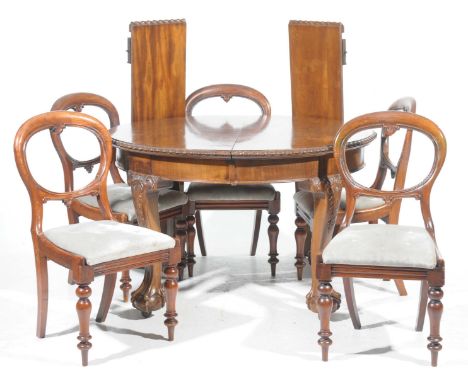 An early 20th Century Chippendale revival extending dining table and five balloon back chairsThe circular table with a gadroo